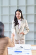 © amnaj - Two asian businesswomen shaking hands after a successful meeting in the office, showing mutual respect and trust