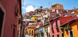 Guanajuato's vibrant hillside houses seen from a narrow street,  travel,   travel photography