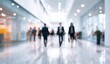 © Samsul - Blurred view of business people in a modern office hallway