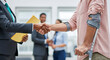 © Mei Studio - Businessman shaking hands with injured employee in office meeting