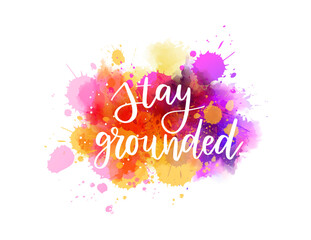 Wall Mural - Stay grounded - handwritten modern calligraphy inspirational text on pink and purple colored watercolor paint splash.