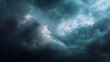 © Thares2020 - Dramatic stormy clouds fill the vast sky with dark moody textures where bright light breaks through creating an intense weather atmosphere