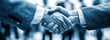 © Dewi - Business handshake in a crowded room
