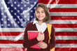 © New Africa - Student with backpack and notebooks against flag of USA. Language school