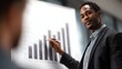 © Thares2020 - Professional African American man presenting a bar growth chart to a client during a focused corporate business meeting emphasizing financial