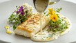 © Daryna - Premium veloute sauce being poured over pan-seared white fish fillet garnished with vibrant edible flowers and fresh microgreens on elegant white plate