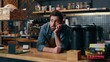 © Yuliia - Disappointed Caucasian waiter man barista boredom in cafeteria exhausted employer problem bartender male entrepreneur leaning counter waitstaff overworking cafe guy contemplate small business stress