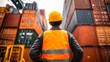 © SuperGlück - Worker monitors container yard during overcast day while managing logistics and operations in shipping industry
