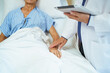 © DG PhotoStock - Doctor and nurse visiting elderly patient in recovery room with care.