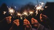 © Pixzart - People holding sparklers at night, celebrating a special occasion with glowing lights