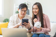 © KMPZZZ - Happy asian young couple love calculate and putting coin in piggy bank for saving money to buy real estate for new home. Business finance, deposit with banking for financial planning future together.
