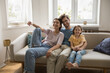 © fizkes - Portrait cheerful bonding couple with kid daughter hugging on sofa