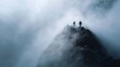 © Thares2020 - Two adventurous hikers stand triumphantly on a rugged mountain summit enveloped in dense atmospheric fog conveying a sense of achievement
