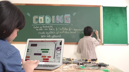 Girl writing engineering prompt by using AI software or programing system to generate AI on table with electronic main board at stem class while smart boy writing software development plan. Pedagogy.