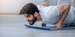 © Prostock-studio - Be safety, new normal and modern workout at apartment in free time. Stay home alone and healthy lifestyle. Attractive young bearded arabian man doing push-ups on mat in minimalist living room interior