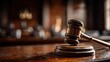 © Tarra - Wooden gavel on a courtroom table.  Blurred background of assembly