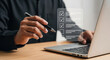 © EdwinGrandas - Person holding pen and using laptop with digital checklist on virtual interface. Concept of productivity, task management and business planning
