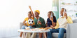 © Prostock-studio - Cheerful black friends young men and women football fans watching game at home, sitting on couch in living room, drinking beer, raising hands up and screaming, celebrating goal, copy space