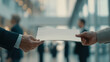 © rungnapha - Businessperson hands over document in modern office setting, symbolizing professional exchange