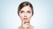 © Png stock - A beautiful woman with blue eyes looks up thoughtfully, her finger on her lips