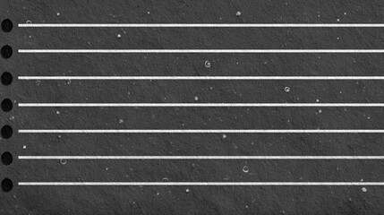 Dark gray textured paper with horizontal lines.
