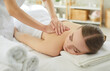 © Studio Romantic - Back massage therapy, professional spa treatment for young woman lying on towel. Hands of professional masseuse and therapist work on therapeutic massage in resort, spa center. Wellness concept