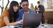 © peopleimages.com - Laptop, books and people at university with studying for test, assignment or exam together. Computer, education and students talking for assessment with research for learning at college campus.