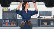 © MyOwnSheep - Empowered mechanic woman repairing car in automotive workshop with tools