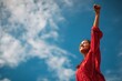 © LimeSky - Joyful Indian girl celebrating set against a cloudy sky from below