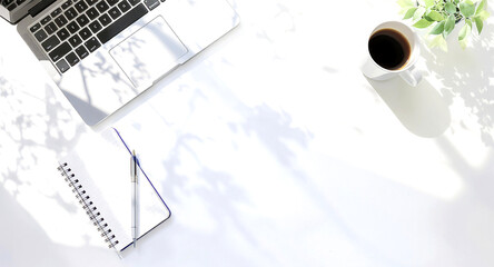 Workspace with Laptop, Notebook, Coffee, and Plant