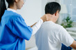 © Nuttapong punna - Healthcare professional assists senior man with shoulder stretch therapy. Ideal for rehab, physiotherapy, aging wellness, pain treatment, and medical care concepts.