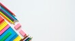 © Ashura - A vibrant assortment of school and office supplies including colored pencils, rulers, and notebooks arranged on a clean white background with ample copy space