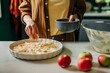 © Westend61 - Baking apple charlotte pie with fresh dough in a cozy country kitchen
