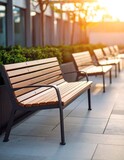 Outdoor benches lined up in a modern urban plaza at sunset