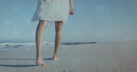 Wall Mural - animation of stars over legs of woman walking on beach