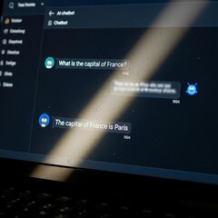 A user interacting with a conversational AI chatbot on a laptop screen