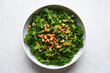 © Khadiza - Healthy chopped kale salad with toasted nuts and dressing