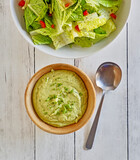 bowl of green goddess salad dressing made with avocado, garlic, basil, cilantro, and thyme