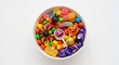 © Steffani - A top down view of a white bowl filled with halloween candy including lollipops and candy corn treats