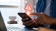 © Sabbir Media - Alerts flash on smartphone screen as person touches display amidst digital icons, signaling cybersecurity concerns.