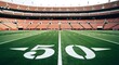 © Saddam StudioX - American football stadium with 50 yard line marker