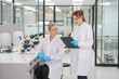 © FotoArtist - Laboratory technicians analyzing samples in a modern research facility during daytime