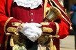 Town crier in the city of Oxford England UK holding his bell while making an announcement, traditional costume stock photo image