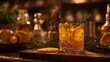 © Anas - Elegant Old Fashioned cocktail with orange garnish, moody bar setting, warm lighting, sophisticated drink photography