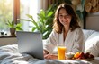 © starush - Woman working on laptop in bright room with natural light and houseplants