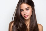 beautiful woman with long, straight hair, showcasing her shiny and smooth hairstyle against a white background