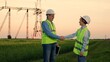 © Victoriia - Team of power engineers, construction workers, woman man working together. Power business, partners making deal. Businessman Businesswoman shaking hands. Engineers teamwork, power plant construction
