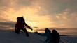 © Victoriia - Teamwork of business people. Go to your goal. Travelers climb snowy mountain together. Silhouettes of climbers reaching out to each other, climbing to top of the hill. Victory of business team. Travel