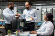 © DC Studio - Team of CAD product designers in office brainstorm solar device for sustainable energy projects. Teamworking green tech company coworkers design solar gadget prototype to reduce environmental impact