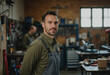 © Aliaksandr Barouski - Repair shop specialist standing confidently beside workshop equipment